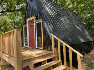 a house with a deck and a red door at Stave Mill Park in Marshall