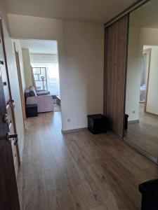 una sala de estar vacía con sofá y espejo en Apartamentai SMILGA, en Klaipėda