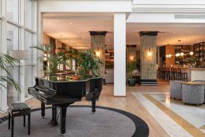 a piano in the lobby of a hotel at Onyria Quinta da Marinha Hotel in Cascais