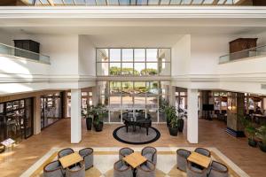 a view of the lobby of a building with a table and chairs at Onyria Quinta da Marinha Hotel in Cascais
