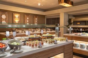 a buffet line with food on display in a restaurant at Onyria Quinta da Marinha Hotel in Cascais