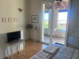プーラにあるVilla Fatta di Sogniのベッドとテレビとバルコニーのある寝室