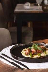 a plate of food on a table with a plate of food at Onyria Quinta da Marinha Hotel in Cascais