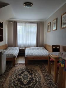 Postel nebo postele na pokoji v ubytování Villa Pod Dębem