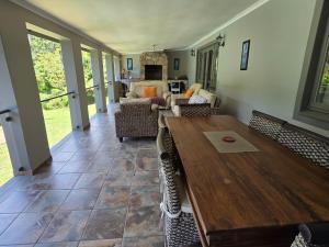 a living room with a wooden table and chairs at Peaceville in Port Shepstone