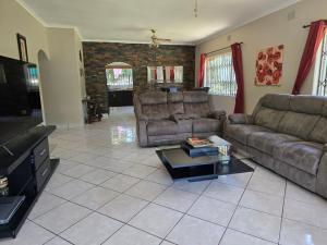 a living room with two couches and a coffee table at Peaceville in Port Shepstone
