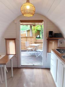 a kitchen with a door open to a patio at Chalet Beau Rivage in Gunsbach