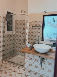 a bathroom with a sink and a glass shower at D'Aiano Guest House B&B in Castel dʼAiano +25 photos