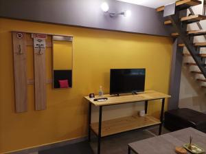 a room with a desk with a tv and a bunk bed at The Urbanite in Kavála +7 photos
