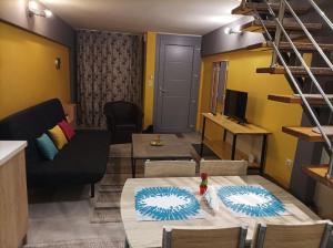 a small living room with a table and a couch at The Urbanite in Kavála