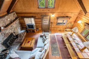 an overhead view of a living room in a log cabin at Log Cabin w Loft, Hot Tub, Deck, Fire Pit, & WiFi in Great Cacapon