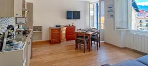 a kitchen with a table and a dining room at la Strecia in Stresa