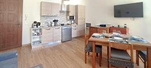 a kitchen with a wooden table and a dining room at la Strecia in Stresa