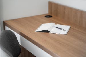 a desk with a notebook and a pen on it at The Q Bliss - your new 4-star hideaway with a garage in Rovinj