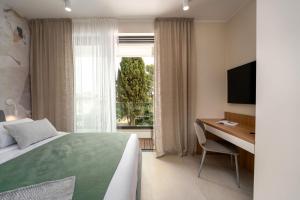 a bedroom with a bed and a desk and a window at The Q Bliss - your new 4-star hideaway with a garage in Rovinj