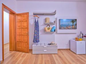 a room with a door and a table with shoes at GP34 Affittacamere in Olbia