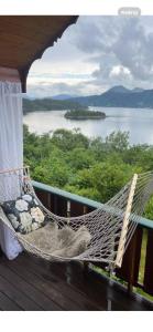 a hammock on a porch with a view of a lake at Domek Iwony in Molde