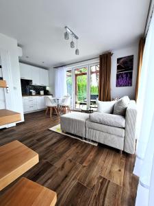 a living room with a couch and a table at Lawendowy Domek Boutique Resort, Zator, Przeciszów in Zator