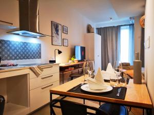 a kitchen and dining room with a table and chairs at Avya's Studio 117 at Ebene Square, Ebene in Ebene