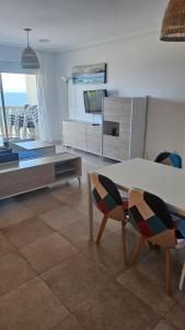 a living room with a bed and a table and chairs at Apartamento Oceano in Barreiros