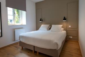 Ένα ή περισσότερα κρεβάτια σε δωμάτιο στο Cœur de Metz Balnéo - La Suite 1