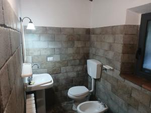 a bathroom with a white toilet and a sink at Teranga in Chianti in Tavarnelle in Val di Pesa