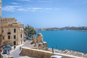 a view of the water and a building and a street at Stylish Seaview Valletta House in Valletta