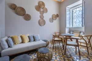 a living room with a couch and a table at Stylish Seaview Valletta House in Valletta