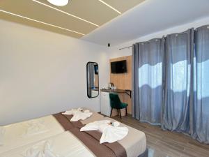 a bedroom with a bed with towels on it at Elafonisi Paradise with Parking, WiFi, - Walking Distance to the Beach in Elafonisi