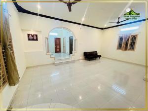 a living room with a ceiling fan and a couch at Shree Anugraha Home Stays in Tiruvannāmalai