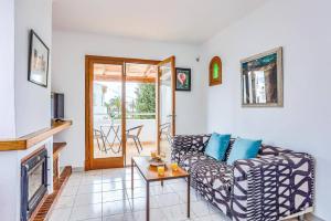 a living room with a couch and a fireplace at Villa Rigo by Villa Plus in Cala D'or