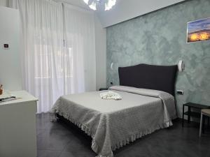 a bedroom with a bed with a table and a window at B&B Nazionale in Naples