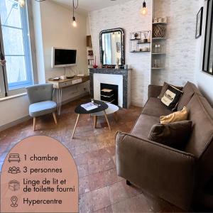 a living room with a couch and a fireplace at Côté Escaliers - Cosy appartement au cœur de Blois in Blois