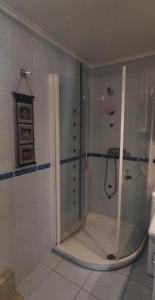 a shower with a glass door in a bathroom at Apartmán pod Magnóliou in Trenčín +9 photos