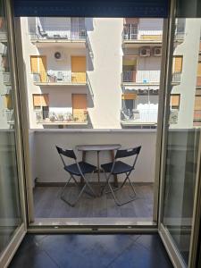 a table and two chairs in a room with a window at B&B Nazionale in Naples