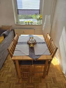 a dining room table with two chairs and a window at Strandapartment in Breitungen in Breitungen +10 photos