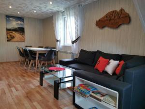 a living room with a couch and a table at Malinowa Chata Murzasichle in Murzasichle