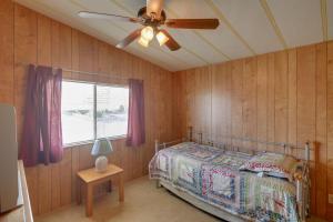 a bedroom with a bed and a ceiling fan at Bullhead City Home with Fire Pit - Walk to CO River! in Bullhead City