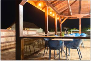 a patio with a table and chairs on a deck at La Relian in Partizanii