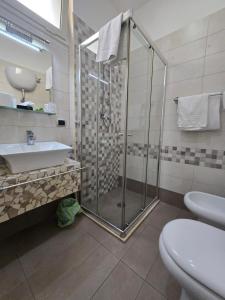 a bathroom with a shower and a sink and a toilet at B&B Nazionale in Naples