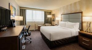a hotel room with a bed and a desk at Holiday Inn Winnipeg-South, an IHG Hotel in Winnipeg