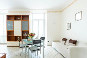 a living room with a couch and a table at Ad un Passo dal Sole by Le Case di Tati in Sanremo