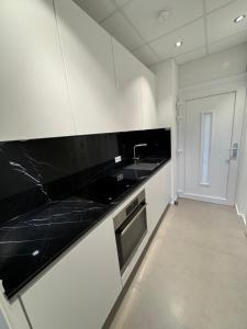 a kitchen with black counter tops and a sink at Exklusives Apartment in Koblenz-Zentrum in Koblenz