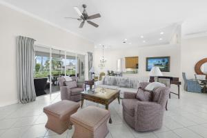 a living room with a couch and chairs and a table at Pet-friendly waterfront home near beach with pool in Marco Island