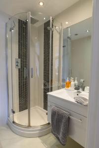 a bathroom with a shower and a white sink at Stunning Liverpool City Location with River View and parking space included in Liverpool