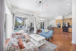 a living room with a couch and a table at Waterfront home on key lot with pool and sundeck in Marco Island