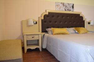a bedroom with a bed and a side table at Villa Grazia in Aci Catena