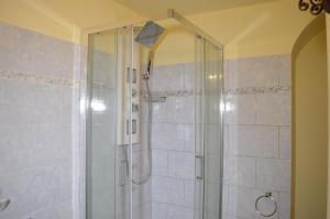 a shower with a glass door in a bathroom at Villa Grazia in Aci Catena +25 photos