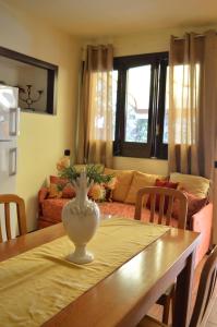 a living room with a table with a vase on it at Villa Grazia in Aci Catena