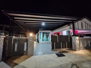 a building with a garage at night at Melaka privatepool bungalow BBQWIFI krubong in Malacca